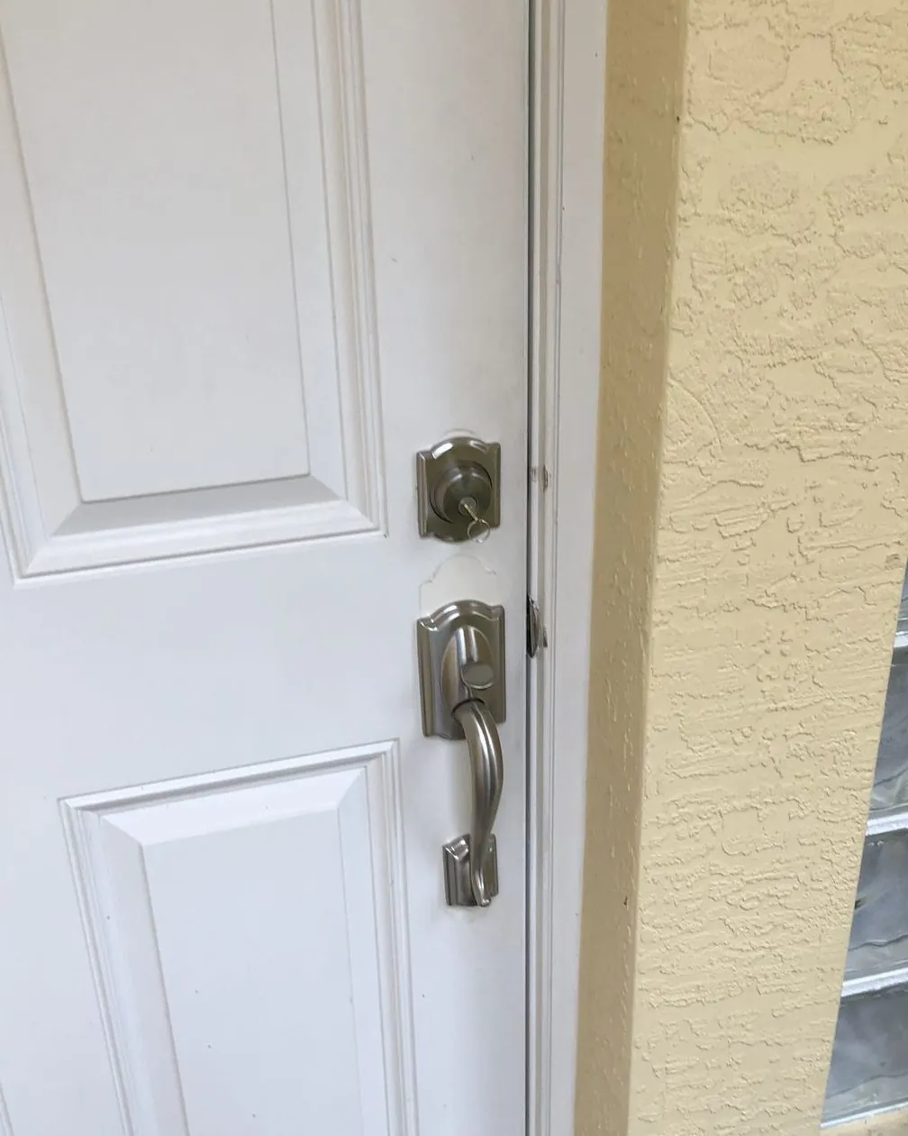 After: new satin nickel deadbolt and handleset on the same white door