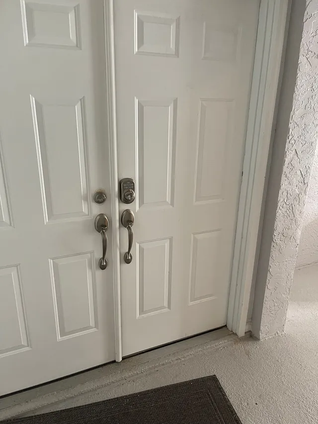 Double doors with a keypad deadbolt and handlesets