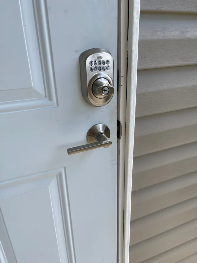 Keypad deadbolt with a matching lever, satin nickel