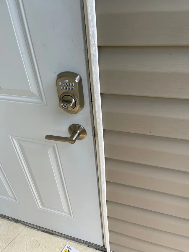 Keypad deadbolt and lever on a white entry door