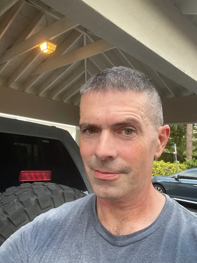 Gary Dickson, owner and locksmith at Sterling Locksmiths, beside the service Jeep